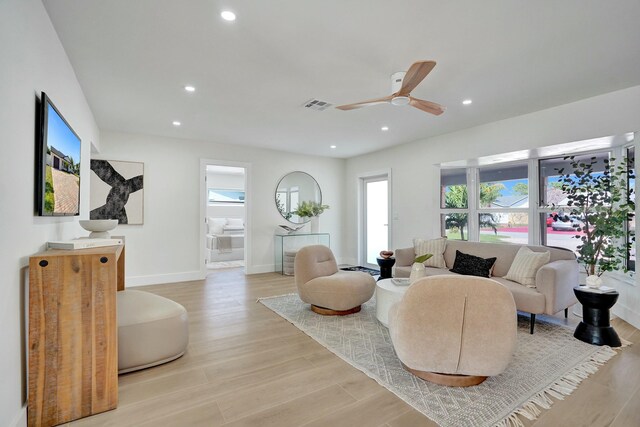 living room with ceiling fan and light hardwood / wood-style floors