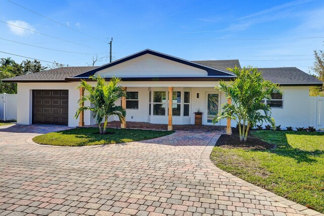 single story home featuring a front yard and a garage