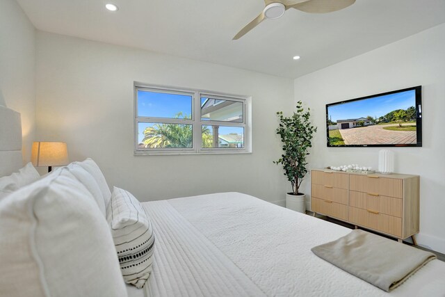 spare room with ceiling fan, plenty of natural light, and light wood-type flooring