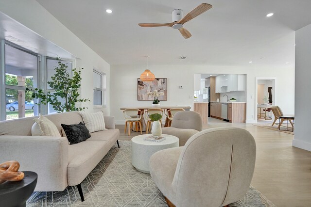 dining area featuring sink and light hardwood / wood-style floors