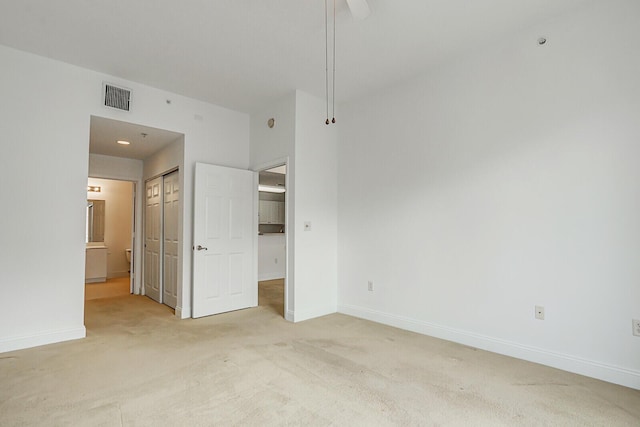 unfurnished bedroom with carpet floors and a closet