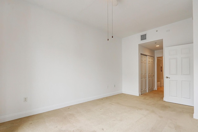 unfurnished room featuring light colored carpet