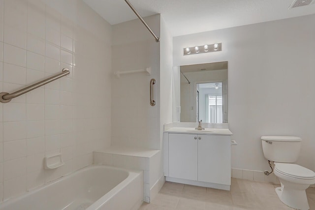 full bathroom featuring toilet, vanity, tiled shower / bath, and tile patterned flooring