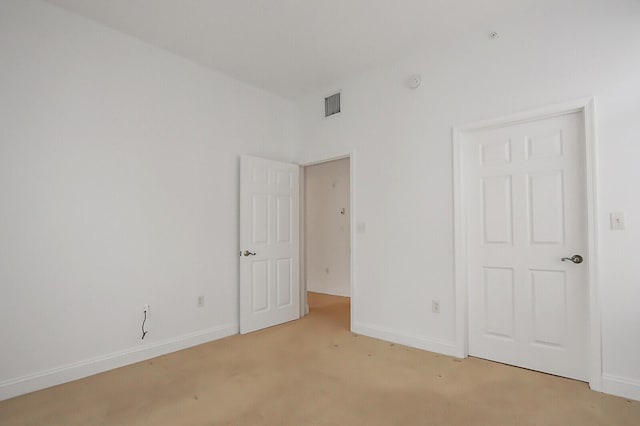 unfurnished bedroom featuring light colored carpet