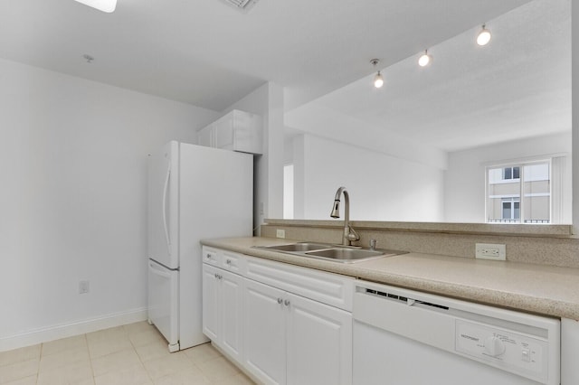 kitchen featuring sink, white appliances, and white cabinetry