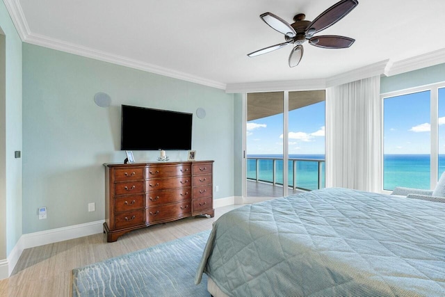 bedroom featuring floor to ceiling windows, access to outside, ceiling fan, light hardwood / wood-style flooring, and crown molding