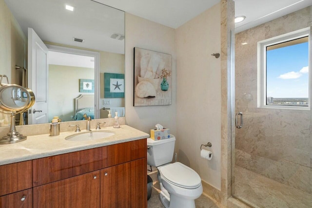 bathroom featuring toilet, a shower with shower door, and vanity