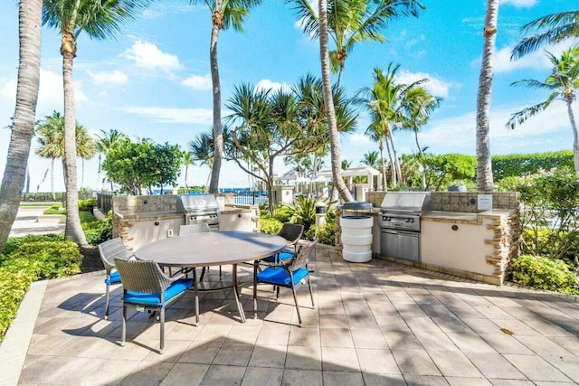 view of patio / terrace featuring a grill and an outdoor kitchen