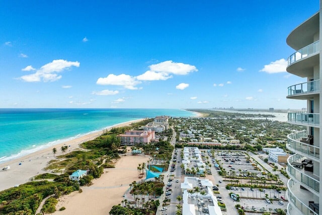 drone / aerial view featuring a water view and a beach view