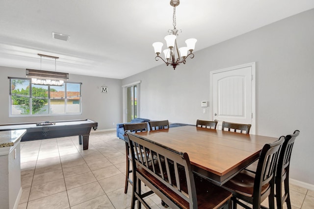 dining area with light tile patterned floors and a chandelier