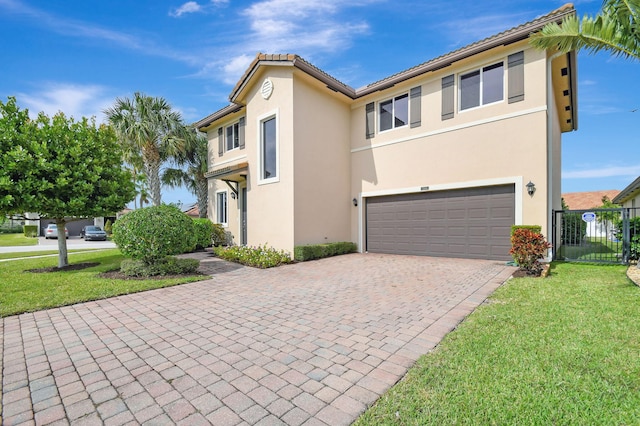 view of front of property featuring a front yard and a garage