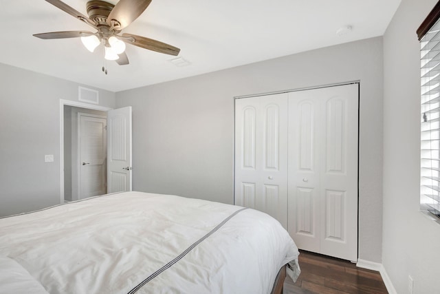 bedroom with ceiling fan, a closet, and dark hardwood / wood-style flooring