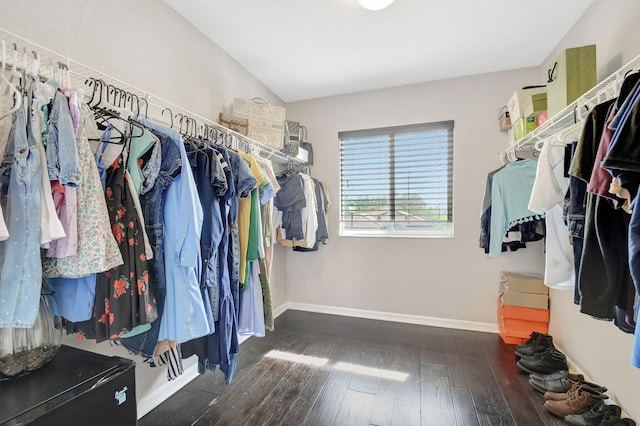 walk in closet featuring dark wood-type flooring and vaulted ceiling