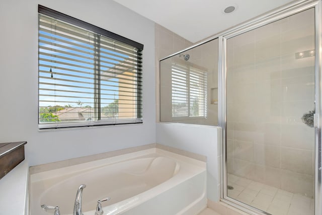 bathroom featuring separate shower and tub