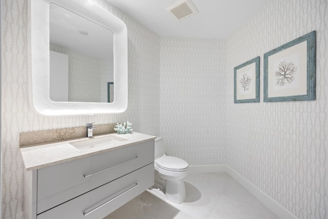 bathroom featuring tile patterned floors, toilet, and vanity