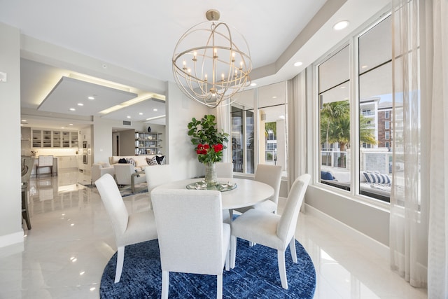 dining area featuring plenty of natural light and an inviting chandelier