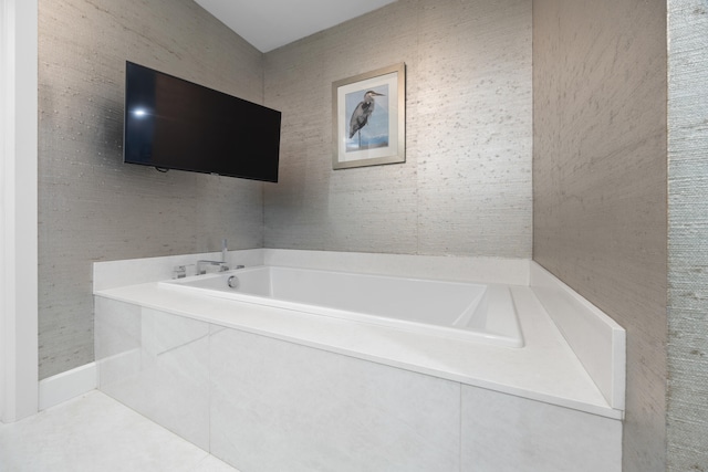 bathroom with tile patterned floors and a bathing tub