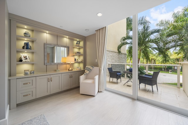 interior space featuring a wall of windows and gray cabinetry