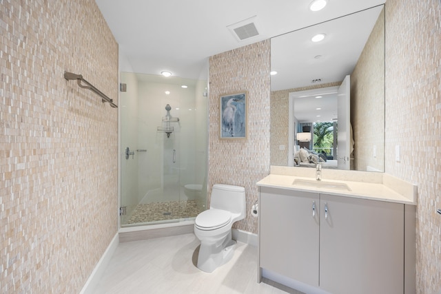 bathroom featuring toilet, vanity, and an enclosed shower