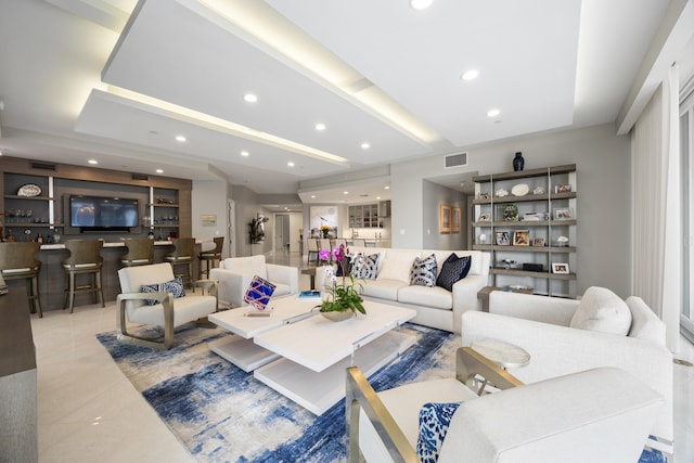 living room featuring light tile patterned floors and bar