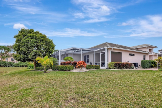 back of house featuring a yard and a lanai