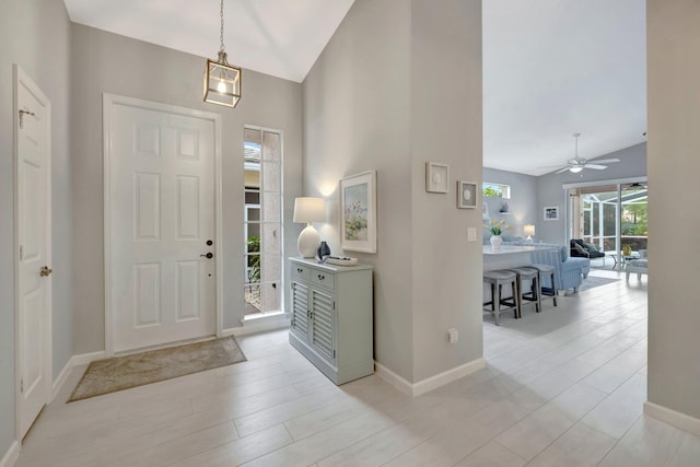 foyer featuring high vaulted ceiling and light hardwood / wood-style floors