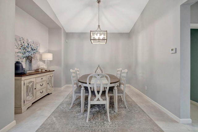 dining area featuring lofted ceiling and an inviting chandelier