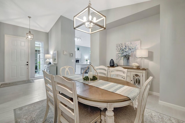 dining room with lofted ceiling and a chandelier