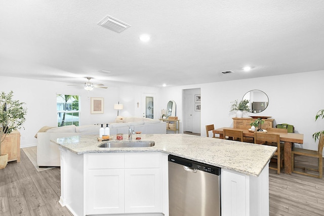 kitchen with light wood-type flooring, white cabinetry, dishwasher, and sink