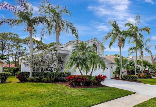 view of front of home with a garage and a front yard