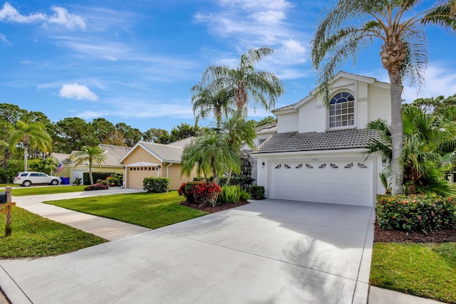 view of front of home with a front lawn and a garage