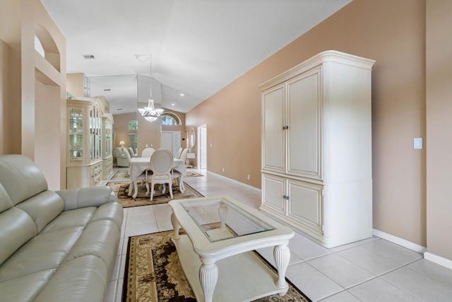 living room featuring vaulted ceiling and light tile patterned floors