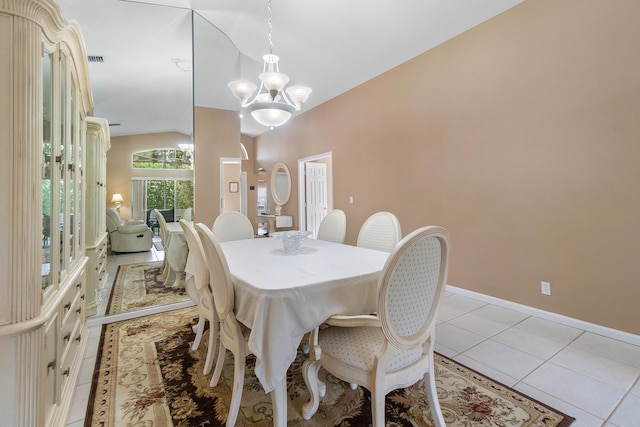 tiled dining area with a chandelier