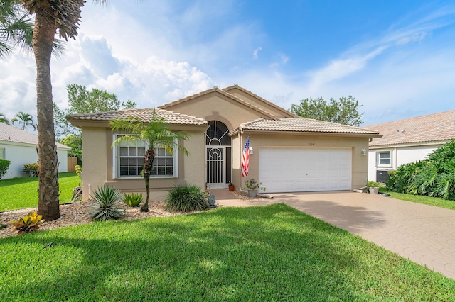 mediterranean / spanish-style house with a front lawn and a garage