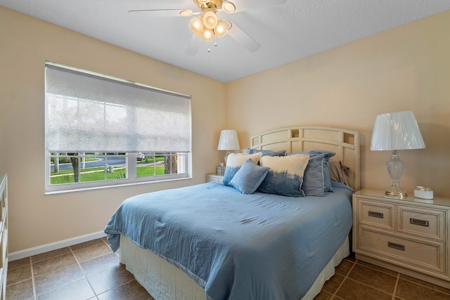 bedroom featuring ceiling fan and dark tile patterned flooring