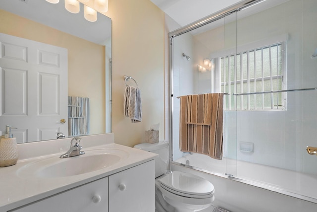 full bathroom featuring combined bath / shower with glass door, vanity, and toilet