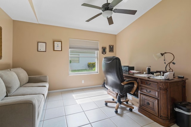 home office featuring ceiling fan, light tile patterned floors, and vaulted ceiling