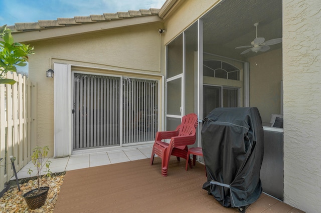 view of patio with ceiling fan, a wooden deck, and area for grilling