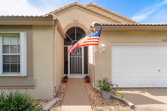 doorway to property with a garage