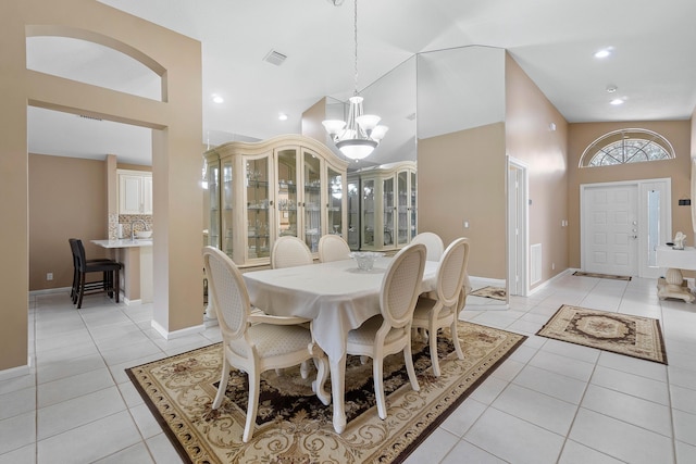 tiled dining room with a chandelier