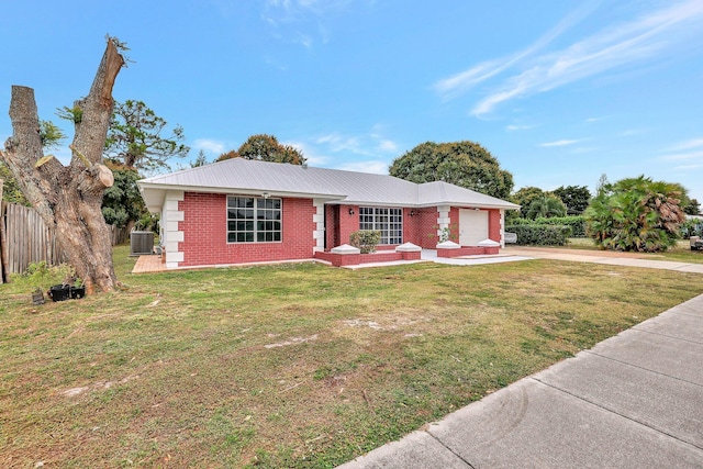 ranch-style house with a front yard, central AC, and a garage