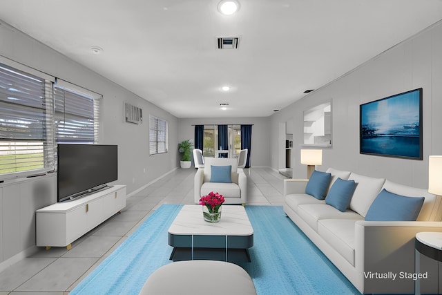 living room with light tile patterned floors and a healthy amount of sunlight