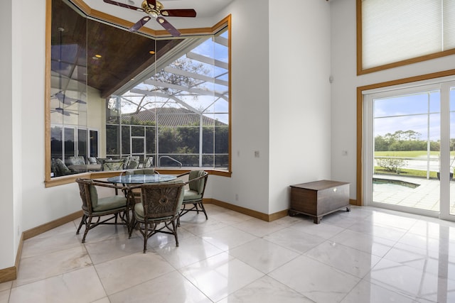 tiled dining area with ceiling fan