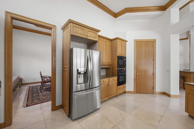 kitchen featuring a high ceiling, ornamental molding, light brown cabinets, and black appliances