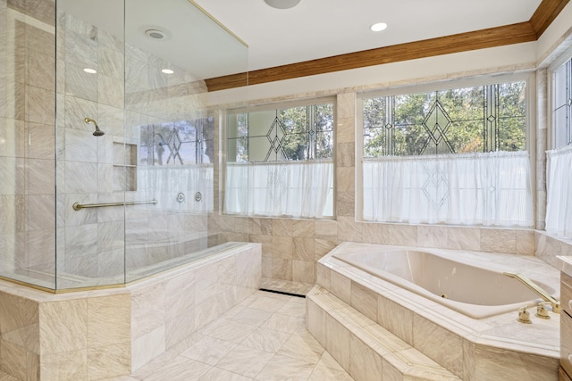 bathroom featuring ornamental molding and tiled bath