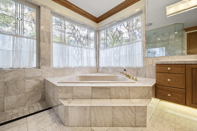 bathroom featuring a wealth of natural light, ornamental molding, and separate shower and tub