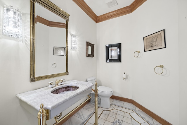 bathroom with ornamental molding, sink, tile patterned floors, and toilet