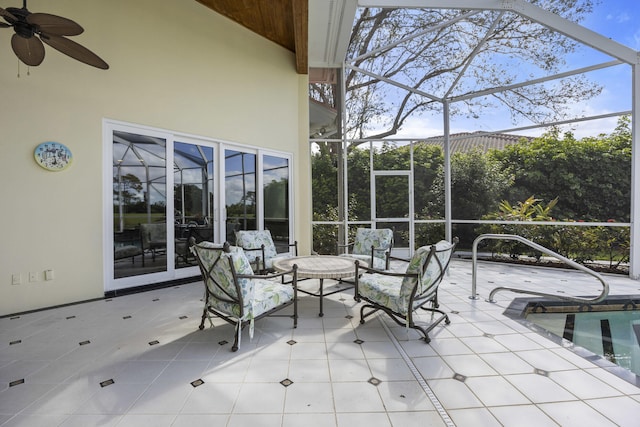 view of patio / terrace with ceiling fan and a lanai