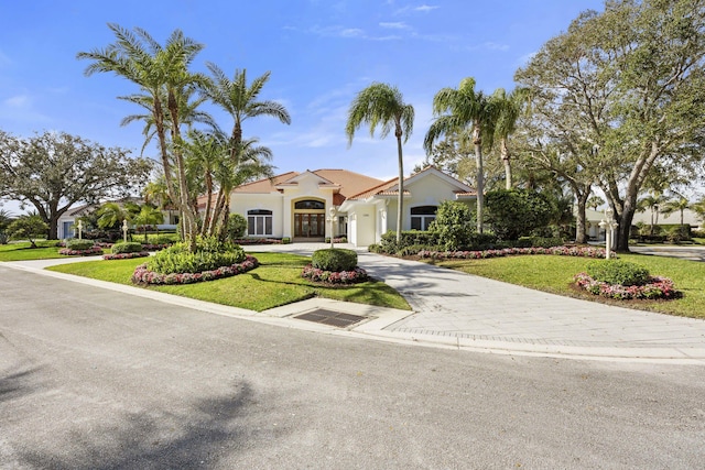 mediterranean / spanish home with a front yard