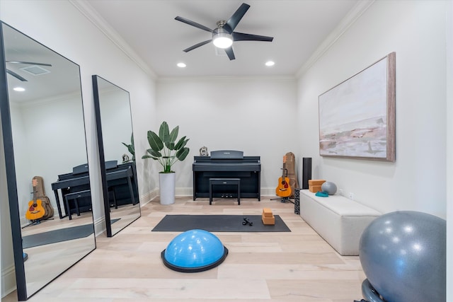 workout room featuring ceiling fan, ornamental molding, and light hardwood / wood-style floors